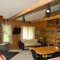 The Loft Log Cottage sleeps up to 13 people.