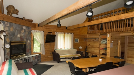 The Loft Log Cottage sleeps up to 13 people.